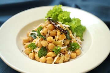 A bowl of fancy salad served on a white plate