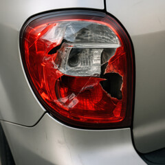 Cracked Car Taillight with Exposed Bulb and Tape Repairs