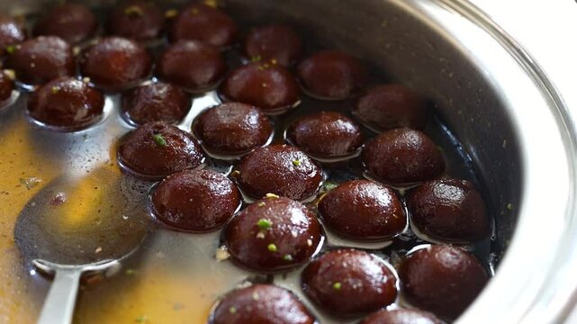 Gulab jamun or kala jaam an indian fried dessert dipped in sugar syrup