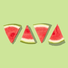 A minimalist graphic design of watermelon slices on a green background.