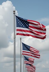 Multiple American flags waving against a cloudy blue sky USA flag United States flag
