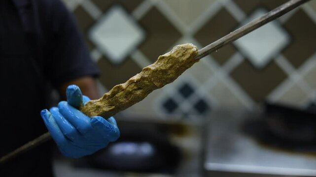 Seekh kebab being made in a kitchen in a restaurant