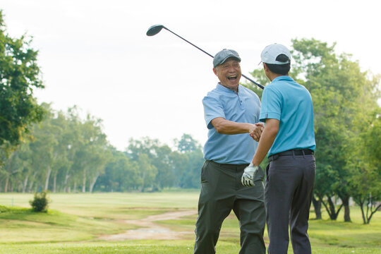 Asian man and elderly father are enjoy playing golf together with a good time. - Powered by Adobe