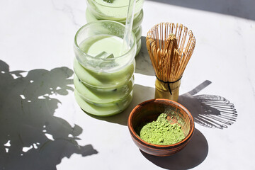 Iced Matcha Refreshment. Refreshing iced matcha drinks with a bamboo whisk and matcha powder