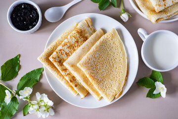 Delicious Breakfast: Large thin pancakes on a white plate on a white plate. Top view. Close-up