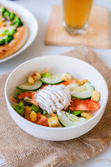 
Fresh vibrant salad with crisp vegetables, croutons, and creamy dressing, accompanied by pizza and drinks, perfect for a healthy and hearty meal.