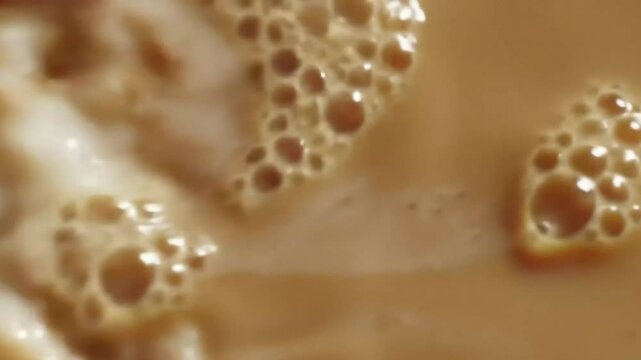 Milk Swirling into Coffee in Slow Motion