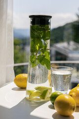 Homemade citrus refreshing summer lemonade drink with lemon, lime and mint in mason jars. Taste of...