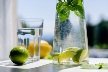 Homemade citrus refreshing summer lemonade drink with lemon, lime and mint in mason jars. Taste of...