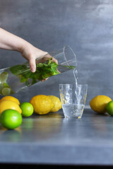 Homemade citrus refreshing summer lemonade drink with lemon, lime and mint in mason jars. Taste of...