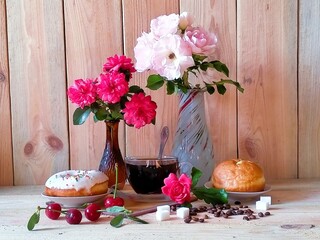 still life with bouquets of roses, a glass cup of coffee, donuts with cream and glaze, cherries,...