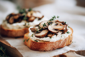 Enjoy a delightful autumn breakfast featuring toasted bread topped with mushrooms, cream cheese, and fresh thyme. Perfect for a cozy morning meal