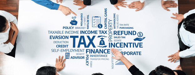 Group of Business Professionals Engaged in Tax Planning Discussion with Financial Terms Illustrated...