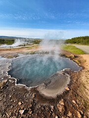 Blue geothermal pool in volcanic landscape in Iceland