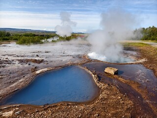 Blue geothermal pool in volcanic landscape in Iceland