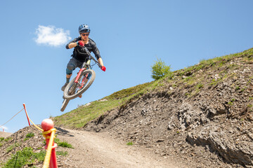 Man biking downhill in the Alps with extreme passion