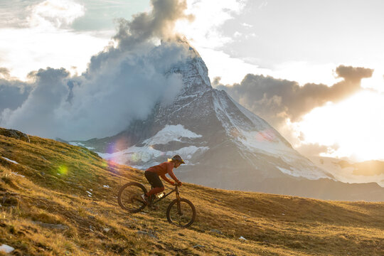 Man biking downhill in the Swiss Alps