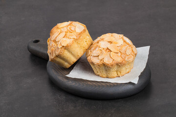 Vegan Almond cake. On a wooden board. Dark background. 