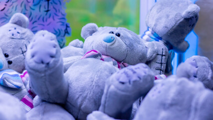 A delightful group of cuddly teddy bears is laying on top of one another