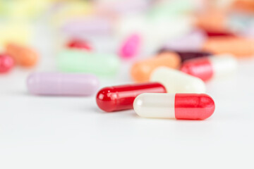Close-up of a red and white antibiotic capsule pill, a pharmaceutical medicine for health treatment with a blurred background