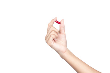 A female hand holding up a red medicine capsule or pill for health and wellness treatment, isolated on white background with clipping path.