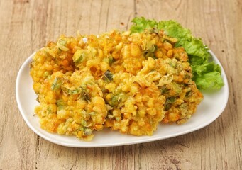 Perkedel Jagung or Bakwan Jagung, corn fritters is Indonesian traditional food. Savory snack made of corn, egg, flour, spring onion, pepper and salt.