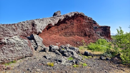Red volcanic rock formations formed by lava in Iceland, abstract landscape