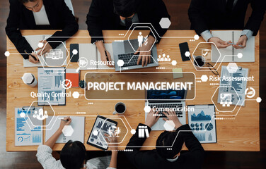 A bird-eye view of a team engaged in project management, highlighting collaboration, planning, and...