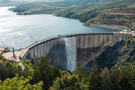 Dam in Atazar reservoir releasing water after rain