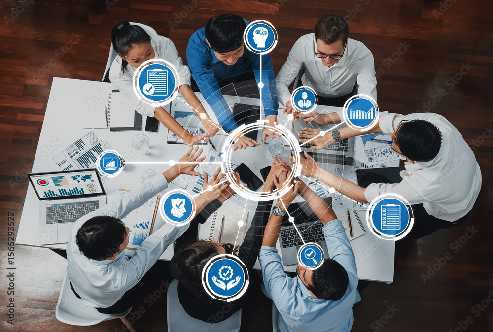 Poster a top-down view of a business meeting with professionals collaborating to analyze data and make deci