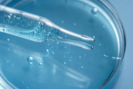 Cosmetic pipette and petri dish with blue liquid