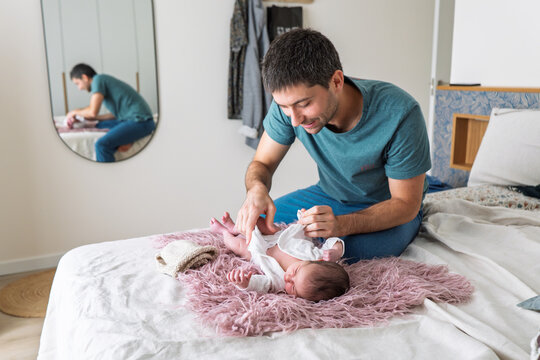 Father bonding with newborn during diaper change
