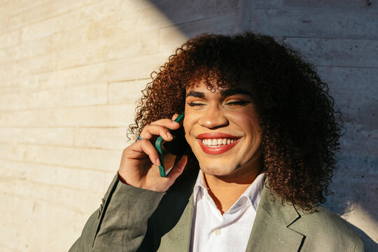 Trans woman working outdoors with phone call