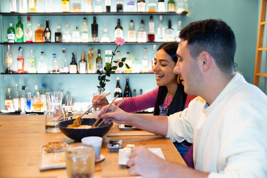 Couple dining in a sushi restaurant enjoying Japanese food