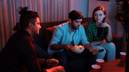 Caucasian father and mother talking with colleague while pick up snack bowl to friend. Happy family...