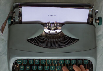 Close-up view of a vintage typewriter featuring the heartfelt phrase i miss you typed on a sheet of...