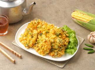 Perkedel Jagung or Bakwan Jagung, corn fritters is Indonesian traditional food. Savory snack made of corn, egg, flour, spring onion, pepper and salt.