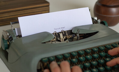 Close-up of a writer's hands typing the motivational phrase you got this on a vintage typewriter,...