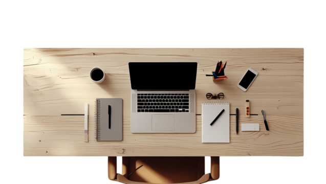 Overhead view of a laptop, coffee, phone, and notebook on a wooden desk, suggesting a workspace or home office.