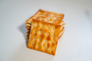 Whole wheat biscuits stacked together on a white background