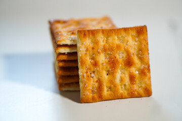 Whole wheat biscuits stacked together on a white background