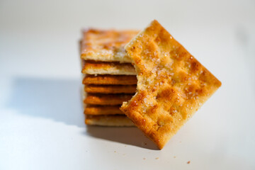Whole wheat biscuits arranged together with one half eaten on a white background