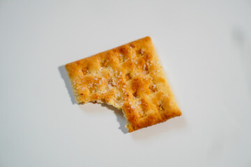 Wheat biscuits with half eaten on white background