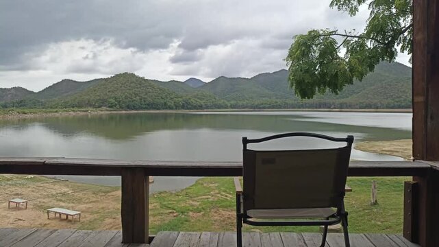 chair on terrace and scenic pond lake mountain view. Calm tranquil nature scenery 