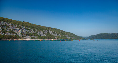 Fototapeta premium Panoramic tour old town of Rovinj, Lim Fjord, Croatia. Aquaculture fish farm mountainous setting.