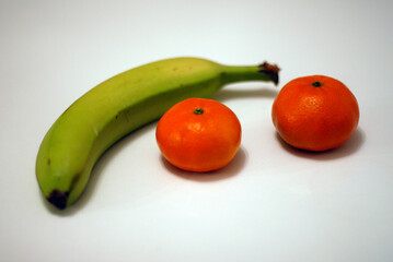 Closeup view of fresh fruit Bananas and Oranges with a small apperture style.