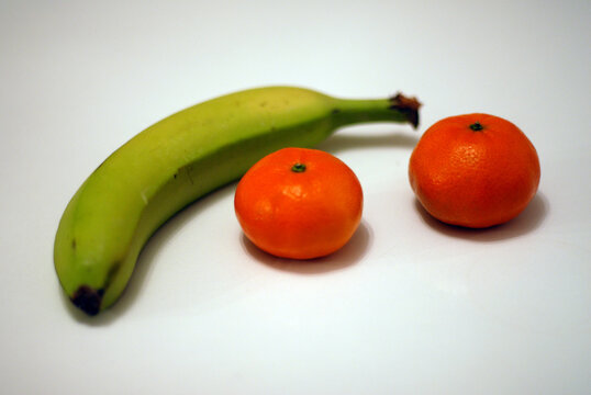 Closeup view of fresh fruit Bananas and Oranges with a small apperture style.
