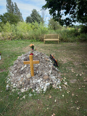 A fresh grave burial mound in a churchyard in England.