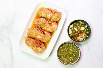 Garlic shrimp stir-fry with Thai spicy seafood dipping sauce on white plate; easy and delicious menu.
