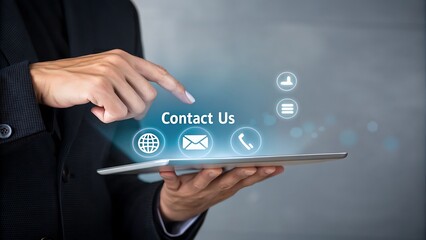 A hand touches a tablet displaying contact us with communication icons